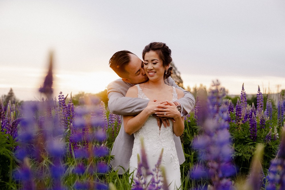 Couple in flower fields at sunset