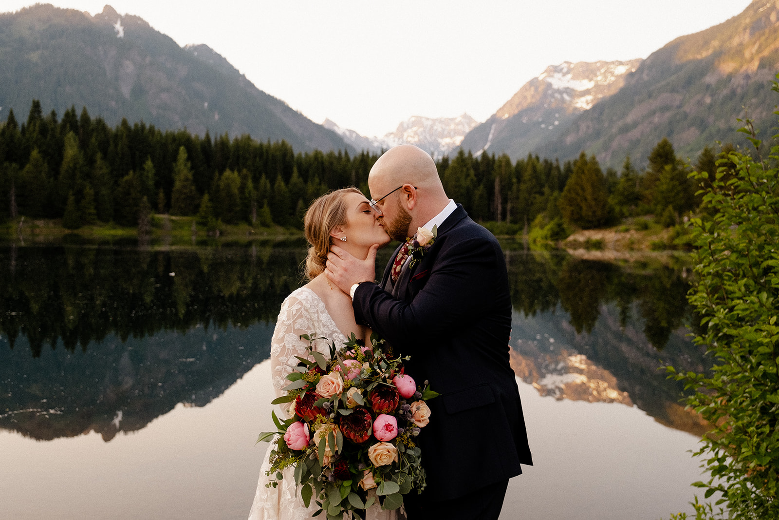 Wedding couple kissing in the mountains