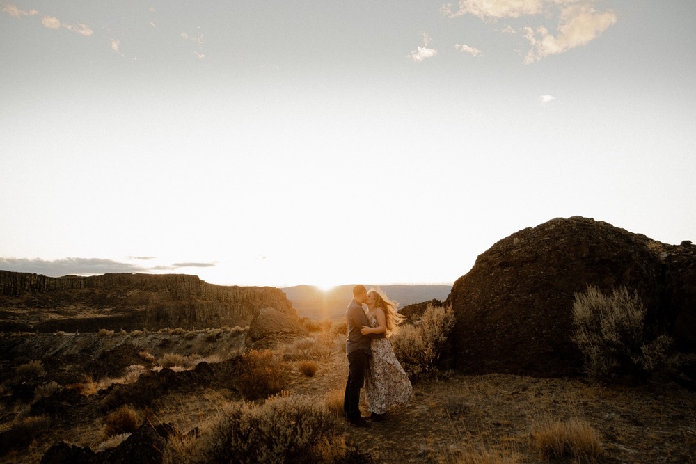 Couple kisses at sunset in the desert of washington state