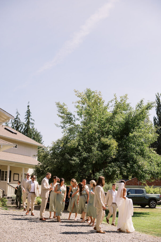 bridal party walks out of house